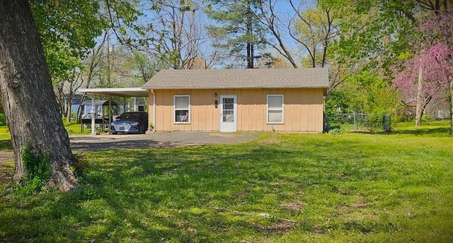 507 E Monroe St, Pittsburg, KS 66762 - view of outdoor structure featuring aphalt driveway, fence, and an attached carport