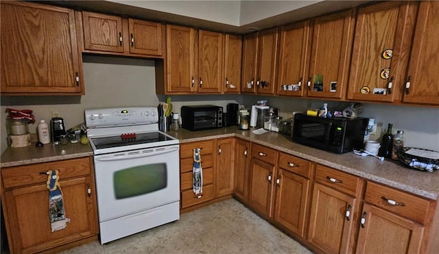 507 E Monroe St, Pittsburg, KS 66762 - kitchen featuring black microwave, light countertops, white electric range oven, and brown cabinets