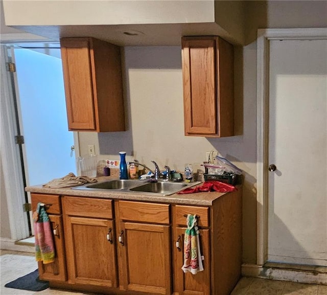 507 E Monroe St, Pittsburg, KS 66762 - kitchen featuring brown cabinets, a sink, and light countertops