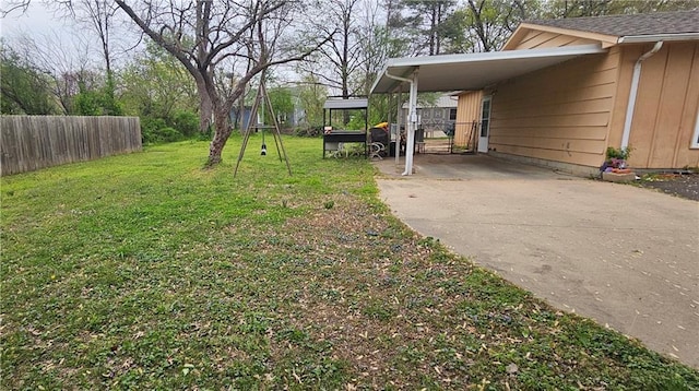 507 E Monroe St, Pittsburg, KS 66762 - view of yard with fence, an attached carport, and concrete driveway