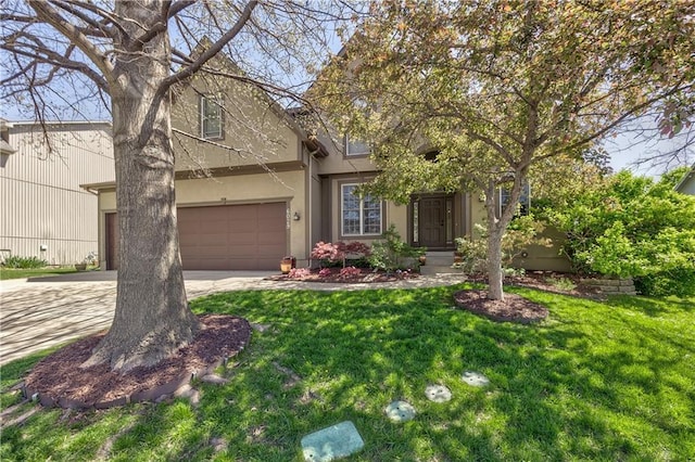 view of front of property with an attached garage, concrete driveway, stucco siding, and a front yard