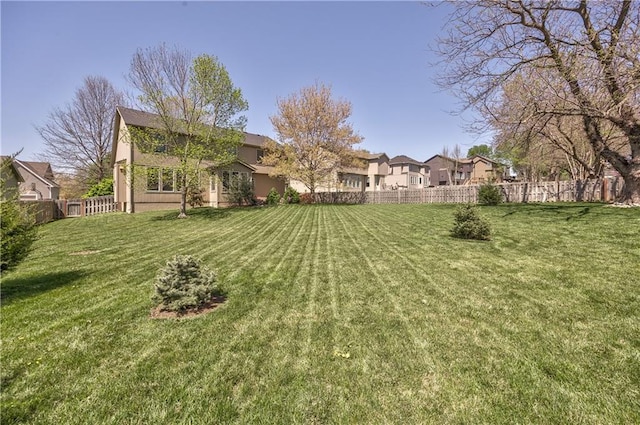view of yard featuring fence and a residential view