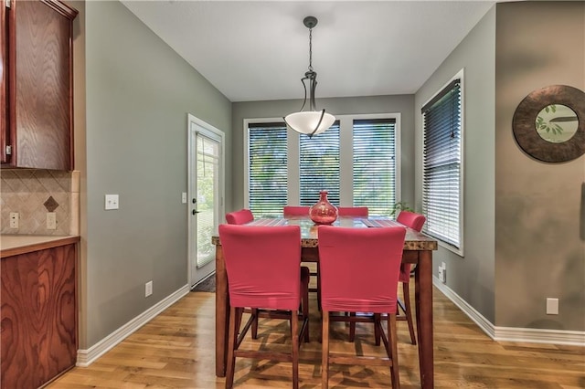 dining area featuring a healthy amount of sunlight, baseboards, and light wood finished floors