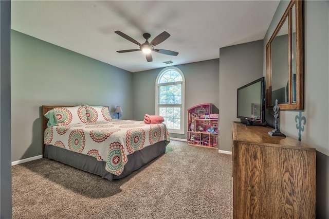 carpeted bedroom with baseboards, a ceiling fan, and visible vents