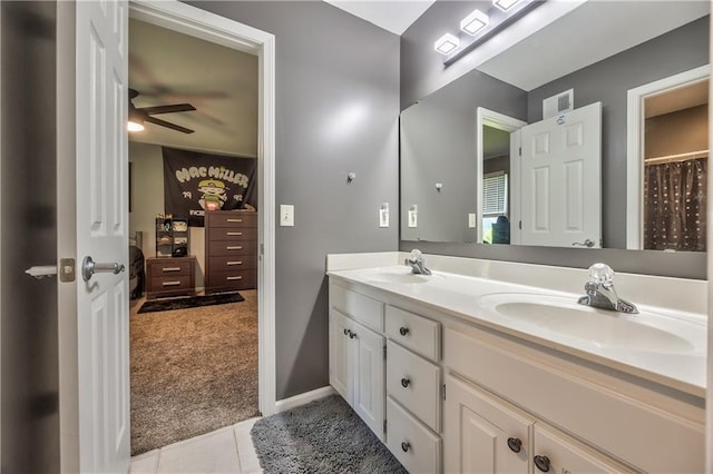 bathroom featuring double vanity, visible vents, a sink, and tile patterned flooring