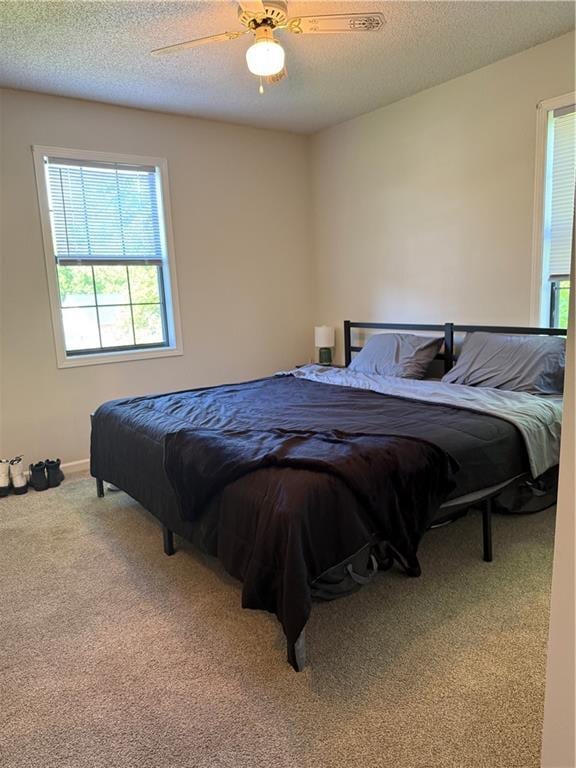 614 SE 145th Rd, Warrensburg, MO 64093 - carpeted bedroom featuring ceiling fan and a textured ceiling