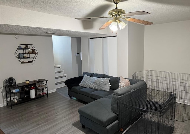 614 SE 145th Rd, Warrensburg, MO 64093 - living area featuring a textured ceiling, wood finished floors, ceiling fan, and stairs