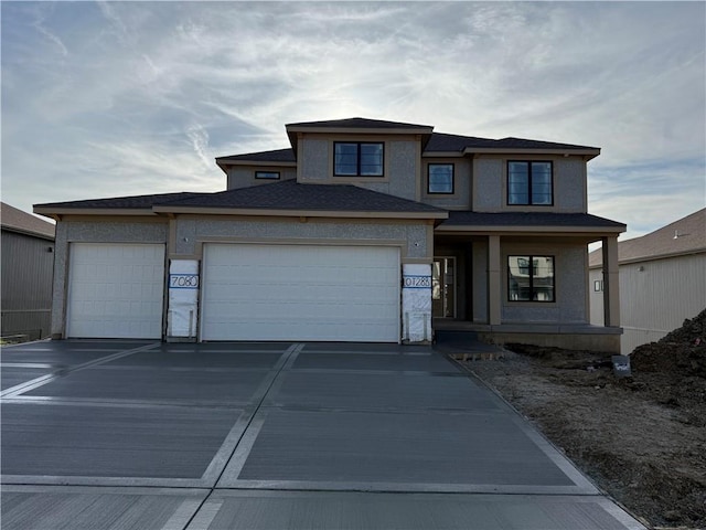 view of front of property featuring stucco siding, covered porch, an attached garage, and concrete driveway