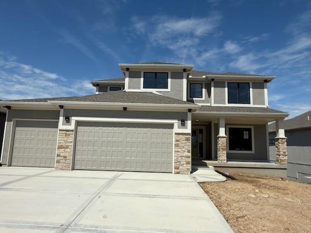 7080 NW Forest Lakes Dr, Parkville, MO 64152 - prairie-style home featuring a porch, an attached garage, driveway, and stone siding