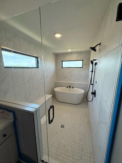 7080 NW Forest Lakes Dr, Parkville, MO 64152 - full bath featuring tile walls, a shower stall, a freestanding bath, and tile patterned floors