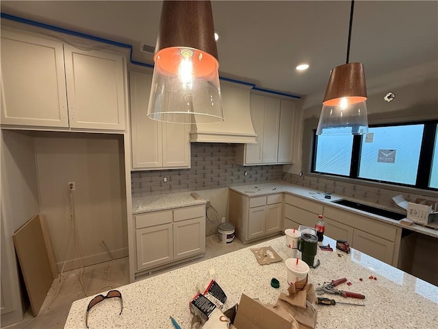 7080 NW Forest Lakes Dr, Parkville, MO 64152 - kitchen featuring custom exhaust hood, light stone counters, decorative backsplash, hanging light fixtures, and recessed lighting