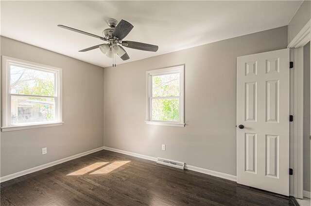 3422 N 71st St, Kansas City, KS 66109 - empty room featuring visible vents, baseboards, ceiling fan, and dark wood-style floors