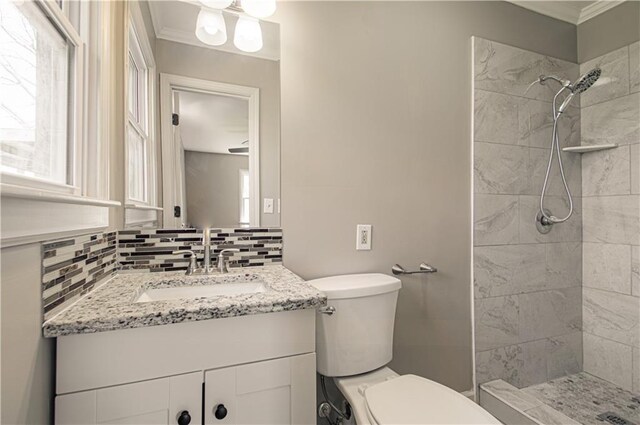 3422 N 71st St, Kansas City, KS 66109 - bathroom with toilet, tiled shower, and ornamental molding