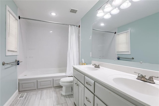 full bath with shower / tub combo, toilet, a sink, and visible vents
