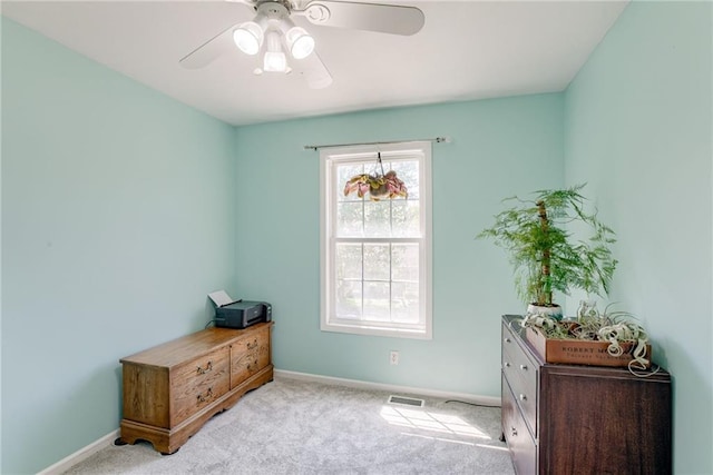 interior space featuring visible vents, baseboards, and ceiling fan
