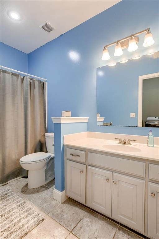 bathroom featuring tile patterned flooring, visible vents, toilet, and vanity