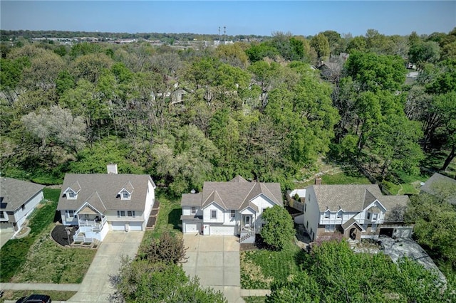 aerial view featuring a forest view and a residential view