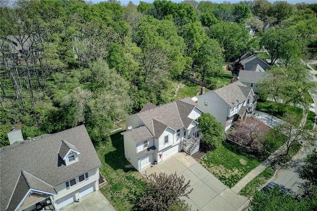 birds eye view of property with a wooded view