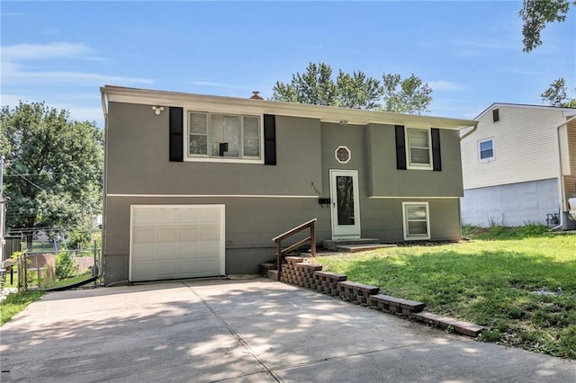 split foyer home with an attached garage and driveway