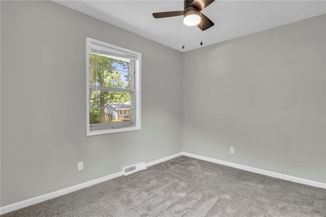 carpeted empty room featuring baseboards and ceiling fan