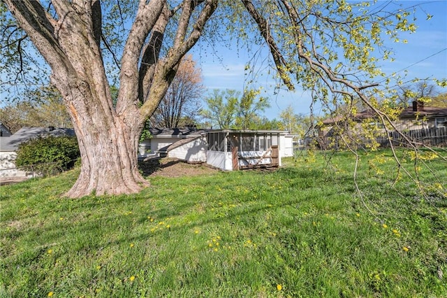 view of yard featuring a sunroom and fence