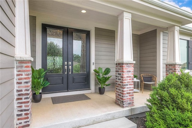 8120 Lone Elm Rd, Lenexa, KS 66220 - property entrance featuring french doors, a porch, and brick siding