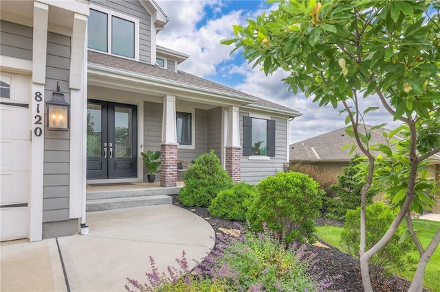 8120 Lone Elm Rd, Lenexa, KS 66220 - view of exterior entry with covered porch and french doors