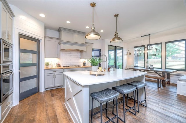 8120 Lone Elm Rd, Lenexa, KS 66220 - kitchen with stainless steel appliances, gray cabinetry, dark wood-type flooring, light countertops, and recessed lighting