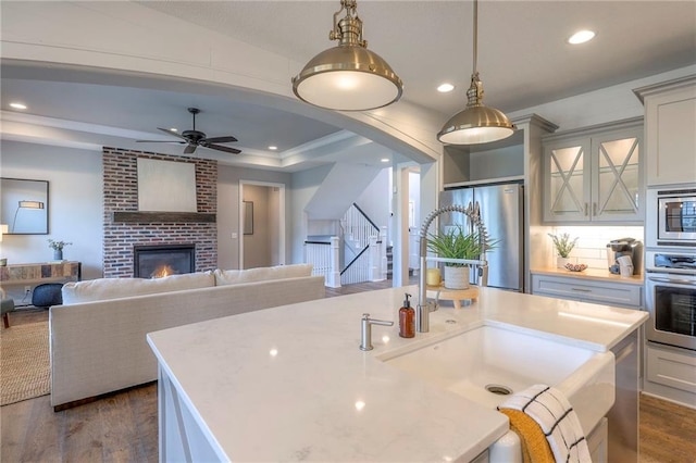 8120 Lone Elm Rd, Lenexa, KS 66220 - kitchen featuring stainless steel appliances, dark wood-style floors, a center island with sink, recessed lighting, and open floor plan