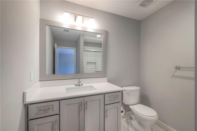 8120 Lone Elm Rd, Lenexa, KS 66220 - full bathroom featuring toilet, vanity, baseboards, marble look tiles, and a textured ceiling