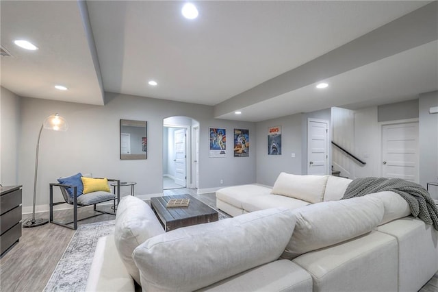 8120 Lone Elm Rd, Lenexa, KS 66220 - living area featuring arched walkways, recessed lighting, baseboards, light wood-type flooring, and stairs
