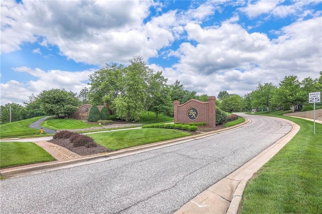 8120 Lone Elm Rd, Lenexa, KS 66220 - view of asphalt road with curbs, traffic signs, and view of wooded area