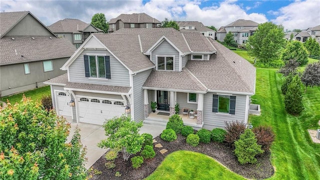 8120 Lone Elm Rd, Lenexa, KS 66220 - view of front of property with roof with shingles, an attached garage, driveway, and a front yard