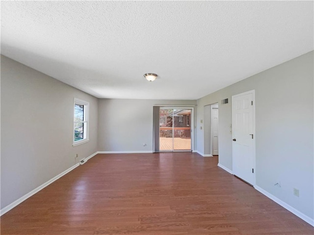 3214 S Hawthorne Ave, Independence, MO 64052 - empty room featuring visible vents, baseboards, wood finished floors, and a textured ceiling