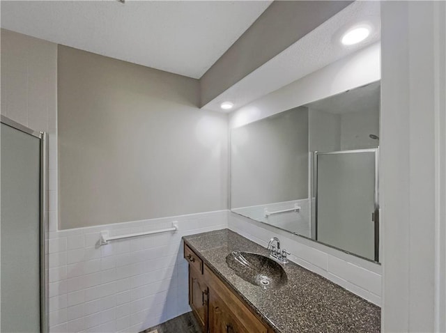3214 S Hawthorne Ave, Independence, MO 64052 - full bath with tile walls, wainscoting, vanity, and a shower stall