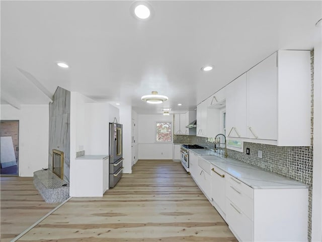 3214 S Hawthorne Ave, Independence, MO 64052 - kitchen with white cabinetry, a sink, high end appliances, and light countertops