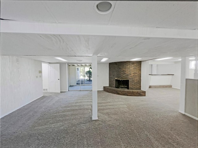 3214 S Hawthorne Ave, Independence, MO 64052 - below grade area featuring carpet, baseboards, and a fireplace