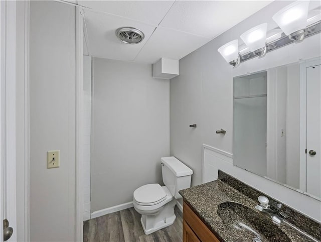 3214 S Hawthorne Ave, Independence, MO 64052 - bathroom featuring toilet, vanity, wood finished floors, and visible vents