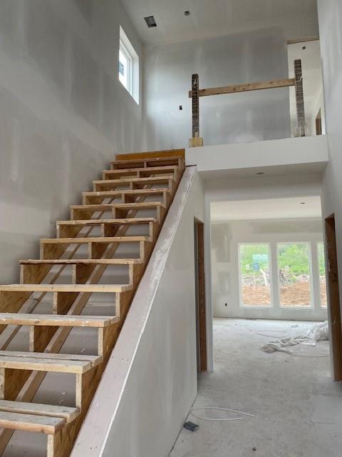 staircase with a towering ceiling