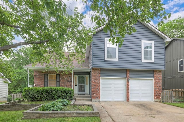 view of front facade with fence, concrete driveway, brick siding, and an attached garage