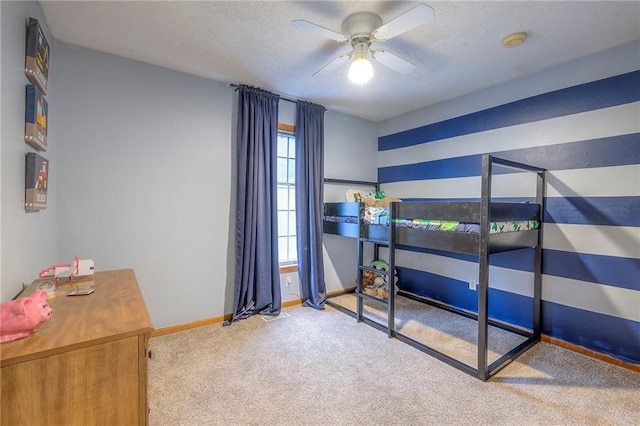 carpeted bedroom with a textured ceiling and baseboards