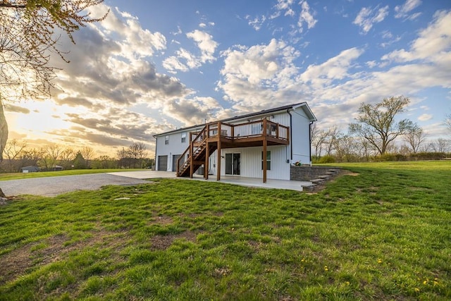 20609 NE 161st St, Kearney, MO 64060 - back of property at dusk with a lawn, a deck, driveway, and stairs