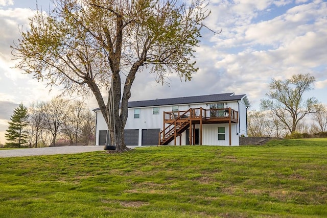 20609 NE 161st St, Kearney, MO 64060 - rear view of house featuring a garage, a wooden deck, driveway, a yard, and stairway