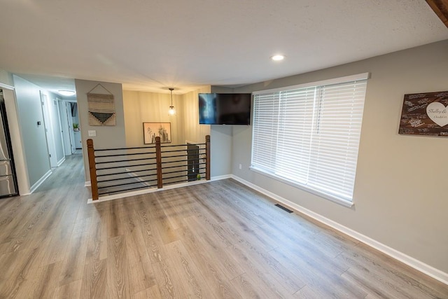 20609 NE 161st St, Kearney, MO 64060 - unfurnished living room featuring baseboards, recessed lighting, wood finished floors, and visible vents