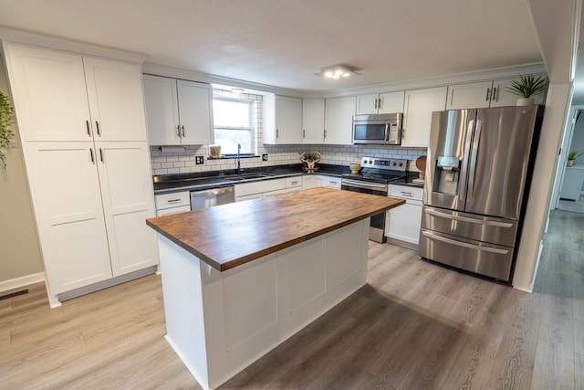 20609 NE 161st St, Kearney, MO 64060 - kitchen featuring appliances with stainless steel finishes, backsplash, light wood-type flooring, and butcher block counters