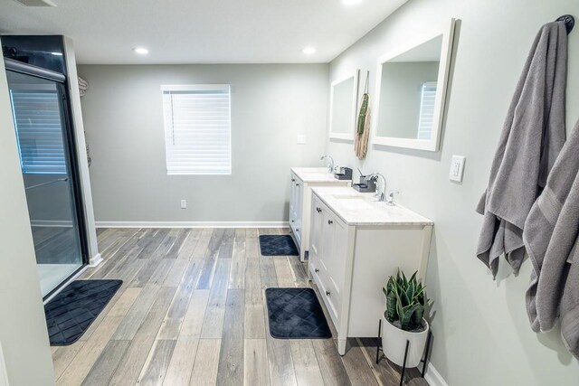 20609 NE 161st St, Kearney, MO 64060 - full bath with double vanity, a sink, wood finished floors, and recessed lighting