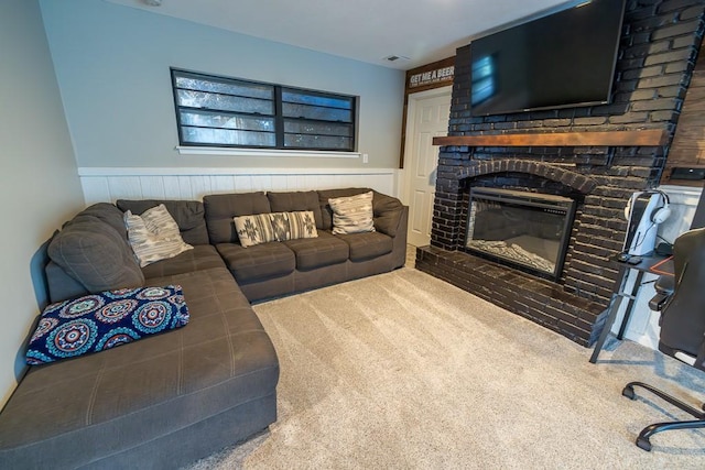 20609 NE 161st St, Kearney, MO 64060 - carpeted living area featuring wainscoting, a brick fireplace, and visible vents