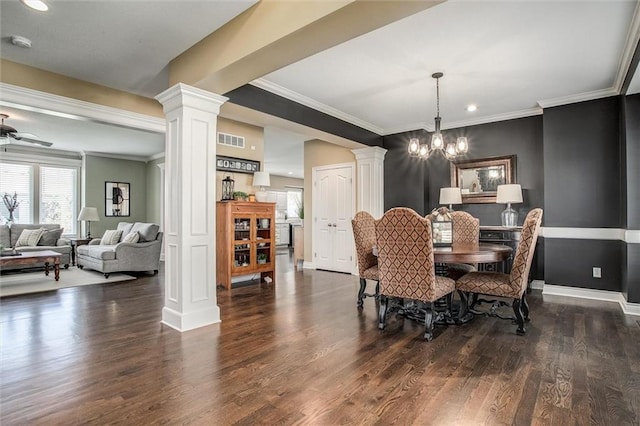 dining room featuring crown molding, visible vents, wood finished floors, baseboards, and ornate columns