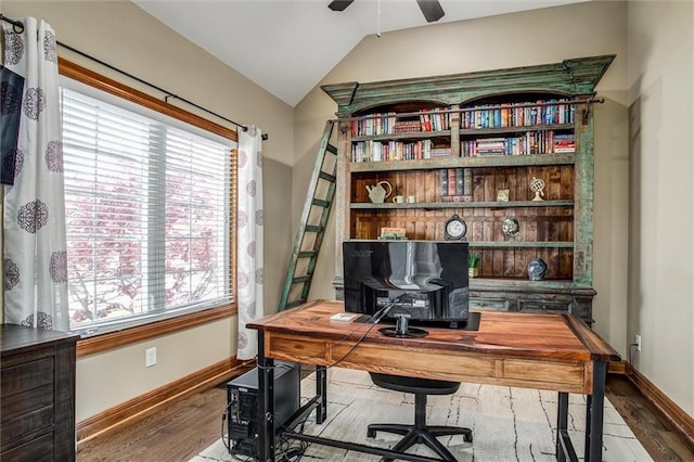 office featuring baseboards, a ceiling fan, lofted ceiling, and wood finished floors