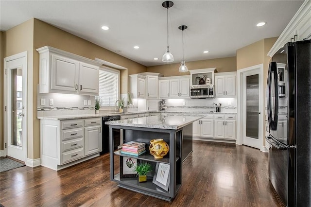 kitchen with white cabinets, open shelves, hanging light fixtures, dark wood-type flooring, and black appliances
